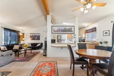 a living room and kitchen with a table and chairs at Lincoln Lodge cabin in Groveland