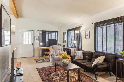 a living room with a couch and a table at Lincoln Lodge cabin in Groveland