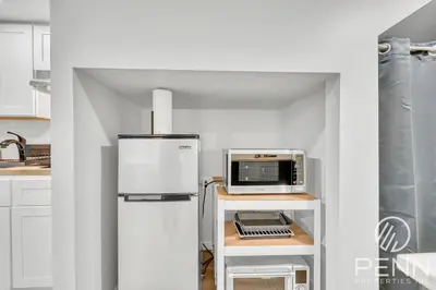 a kitchen with a refrigerator and a microwave at Midtown Gem with Secret Speakeasy in Sacramento