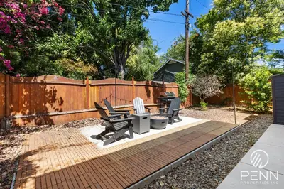 a backyard with a table and chairs and a fence at Midtown Gem with Secret Speakeasy in Sacramento