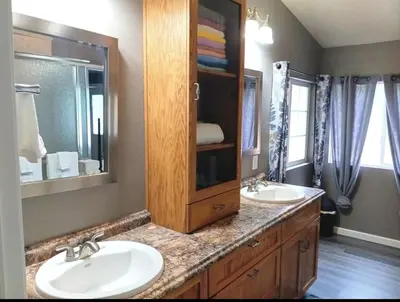 a bathroom with two sinks and a large mirror at Sequoia Eagle Nest in Three Rivers