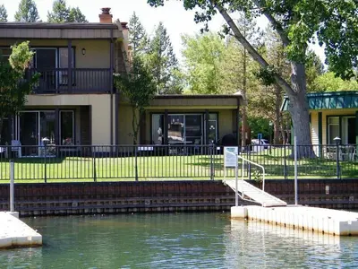 a house sitting next to a body of water at TKC0604 - Betty Ann's Place condo in South Lake Tahoe