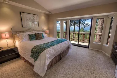 a bedroom with a large bed and a balcony at HCH1221 - Tahoe Bonoff Venture home in South Lake Tahoe