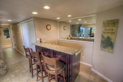 a kitchen with a counter and a bar with chairs at HCH1221 - Tahoe Bonoff Venture home in South Lake Tahoe