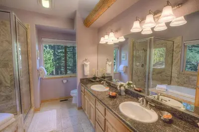 a bathroom with two sinks and a large mirror at COH1669 - Hawk's View Hideaway home in South Lake Tahoe