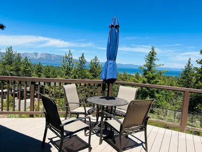 a table with chairs and an umbrella on a deck at HCH1475 - Heavenly Lake View Retreat home in South Lake Tahoe