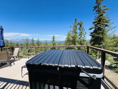 a black table on a deck with a view of trees at HCH1475 - Heavenly Lake View Retreat home in South Lake Tahoe