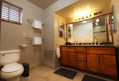 a bathroom with a toilet and a sink and a mirror at COH1261 - Nature's Gem home in South Lake Tahoe