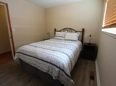 a bedroom with a bed with a white comforter and a window at COH1261 - Nature's Gem home in South Lake Tahoe