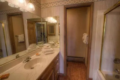 a bathroom with a sink and a large mirror at TKH1226 - Emerald Lodge home in South Lake Tahoe