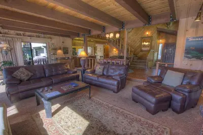 a living room with leather furniture in a house at TKH1226 - Emerald Lodge home in South Lake Tahoe