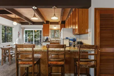 a kitchen with wooden cabinets and a table and chairs at COH0885 - Skyline Divine home in South Lake Tahoe