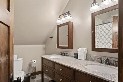 a bathroom with two sinks and a mirror at CYH1012 - Hidden Cedar home in South Lake Tahoe