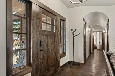 a hallway with a wooden door and windows at CYH1012 - Hidden Cedar home in South Lake Tahoe