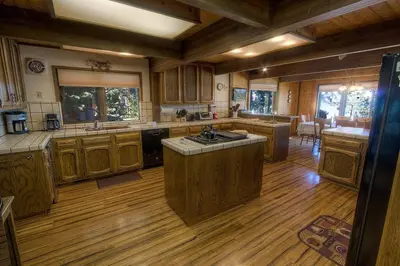 a large kitchen with wooden floors and wooden cabinets at CYH1281- Tahoe Acres home in South Lake Tahoe
