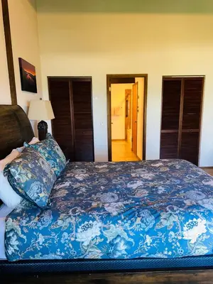 a bedroom with a bed with a blue comforter at CYH1281- Tahoe Acres home in South Lake Tahoe
