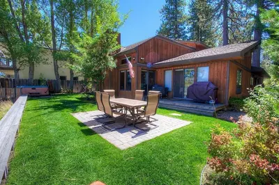 a backyard with a table and chairs and a house at CYH1281- Tahoe Acres home in South Lake Tahoe
