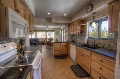 a kitchen with wooden cabinets and a counter top at HCH1217 - Pinehill Ponderosa home in South Lake Tahoe