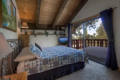 a bedroom with a bed and a balcony at HCH1217 - Pinehill Ponderosa home in South Lake Tahoe