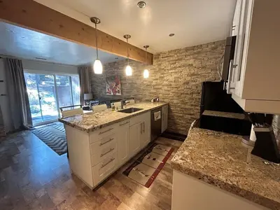 a kitchen with a sink and a brick wall at HCC0410 - Heavenly Hideaway condo in South Lake Tahoe