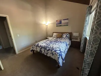 a bedroom with a bed with a blue and white comforter at HCC0410 - Heavenly Hideaway condo in South Lake Tahoe