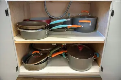 a cupboard with pots and pans on a shelf at HCH1083 - Mountain Serenity home in South Lake Tahoe