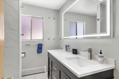 a white bathroom with a sink and a mirror at HCH1083 - Mountain Serenity home in South Lake Tahoe