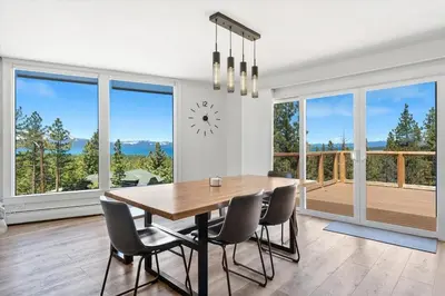 a dining room with a table and chairs and a clock at HCH1083 - Mountain Serenity home in South Lake Tahoe