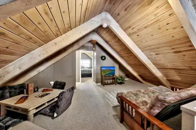 a attic room with a wooden ceiling and a table at CYH0876 - Island Cabin cabin in South Lake Tahoe