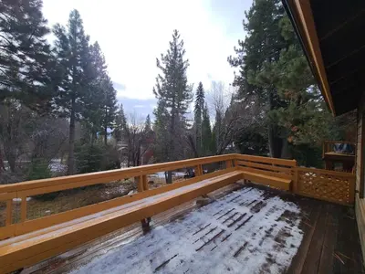 a wooden bench on a deck with snow on it at IVH0869 - Cinnabar Creek home in Incline Village