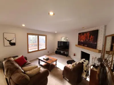 a living room with a couch and a fireplace at IVH0869 - Cinnabar Creek home in Incline Village