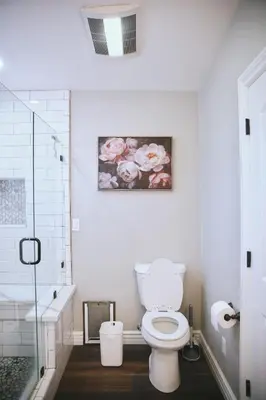 a bathroom with a toilet and a painting on the wall at A Luxury Yosemite Retreat in Mariposa