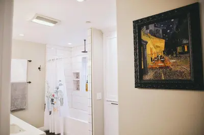 a bathroom with a painting hanging on the wall at A Luxury Yosemite Retreat in Mariposa