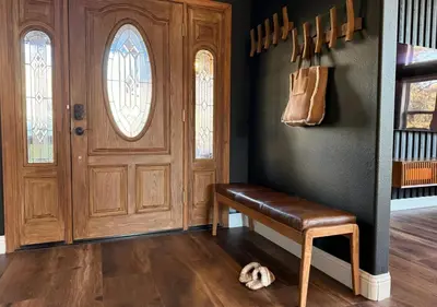 a room with a wooden door and a dog laying on the floor at Elegant Blackwood Grove by Casa Oso in Mariposa