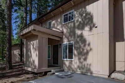 a house with a porch and a building at Golden Antler Escape - Minutes to the Beach in Incline Village