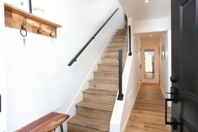 a staircase in a house with white walls and wooden floors at Golden Antler Escape - Minutes to the Beach in Incline Village