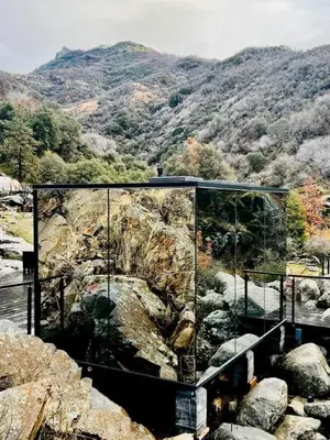 a glass house on top of a rocky mountain at Spacious and Luxurious Barn in Three Rivers, California in Three Rivers