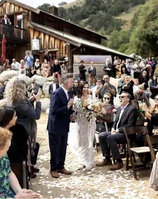 a bride and groom walking down the aisle at their wedding at Spacious and Luxurious Barn in Three Rivers, California in Three Rivers