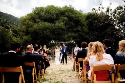 a bride and groom walking down the aisle at their wedding at Spacious and Luxurious Barn in Three Rivers, California in Three Rivers