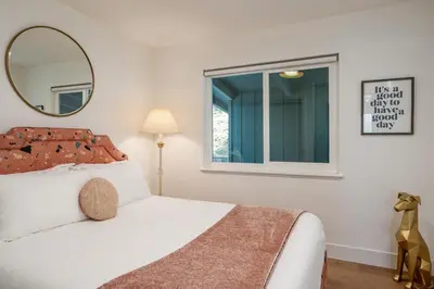 a bedroom with a white bed and a mirror at Sequoia Retreat - Scenic Pool, Hot Tub, & Trails in Three Rivers