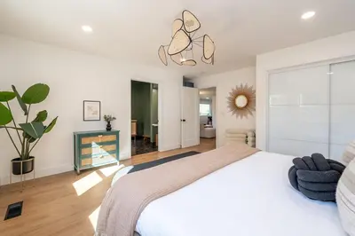 a bedroom with a white bed and a potted plant at Sequoia Retreat - Scenic Pool, Hot Tub, & Trails in Three Rivers