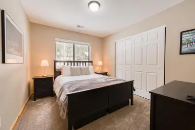 a bedroom with a bed and a white door at Pebble Place at Tahoe Donner by Tahoe Getaways - Pet Friendly, Single Level w HOA in Truckee