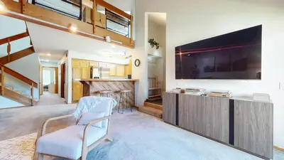 a living room with a large flat screen tv at Snowcreek IV #594 condo in Mammoth Lakes