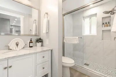 a white bathroom with a shower and a toilet at Mountain Retreat - Lake Tahoe - Incline Village - Private Garage in Incline Village