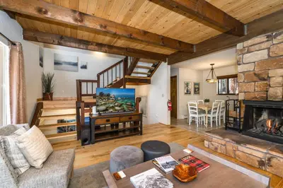 a living room with a staircase and a fireplace at Mountain Escape - Lake Tahoe - Incline Village - Private Garage in Incline Village