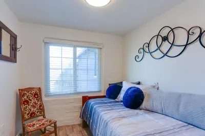 a bedroom with a bed and a chair and a window at Mtn-View Home with Patio and Grill in Woodlake in Woodlake