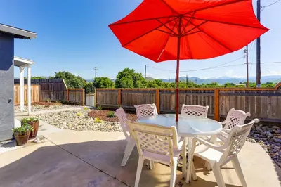 a table and chairs with a red umbrella on a patio at Mtn-View Home with Patio and Grill in Woodlake in Woodlake