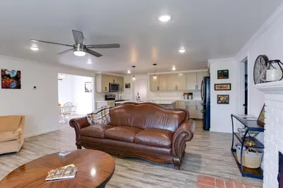 a living room with a leather couch and a kitchen at Mtn-View Home with Patio and Grill in Woodlake in Woodlake