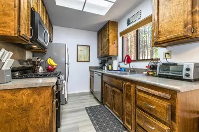 a kitchen with wooden cabinets and a refrigerator at Mountain Getaway - Lake Tahoe - Incline Village - Private Garage in Incline Village