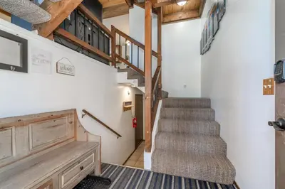 a staircase in a house with wooden ceilings at Mountain Getaway - Lake Tahoe - Incline Village - Private Garage in Incline Village